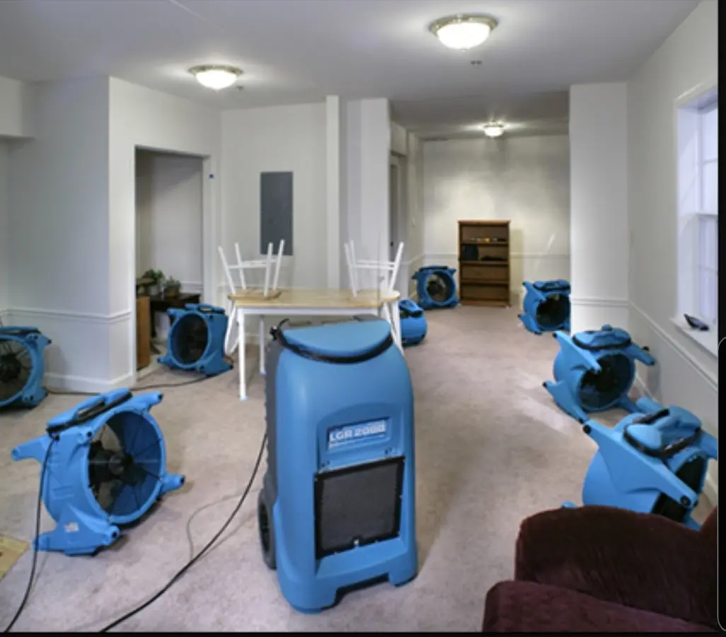 Air movers and dehumidifier setup for Water Damage Restoration in Justin